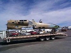 Photo shows an ACL Oshkosh award-winning L-39C aircraft before restoration. This aircraft is on a flat-bed truck, as it is being transported.